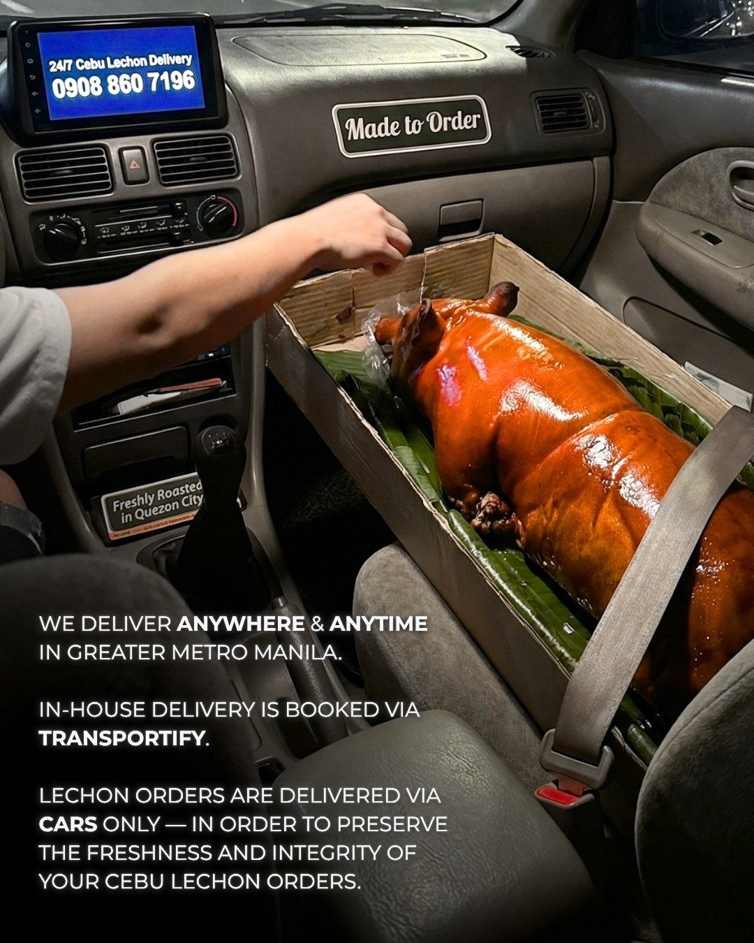 A whole Cebu lechon in an open tray, secured in a car for delivery across Metro Manila