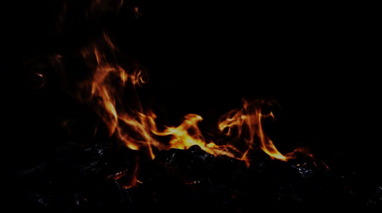Charcoal embers glowing in the roasting pit
