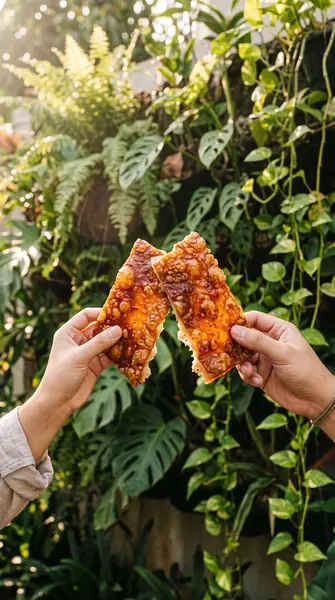Hands clinking lechon skin shards
