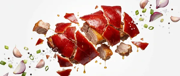 Cebu lechon and aromatics scattered in the air