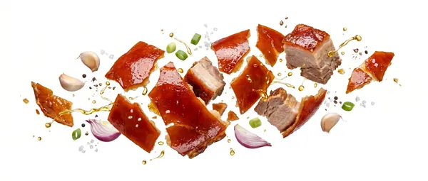 Cebu lechon with aromatics spread across a white ground