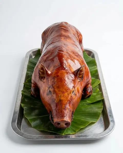 Whole cebu lechon on banana leaf