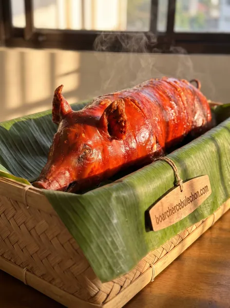 A whole Cebu lechon in a woven basket lined with banana leaf
