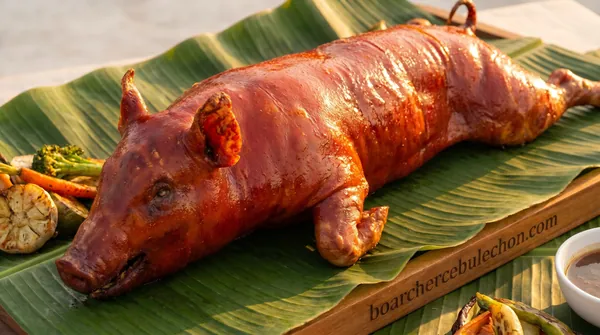 A whole Cebu lechon on banana leaf with roasted vegetables